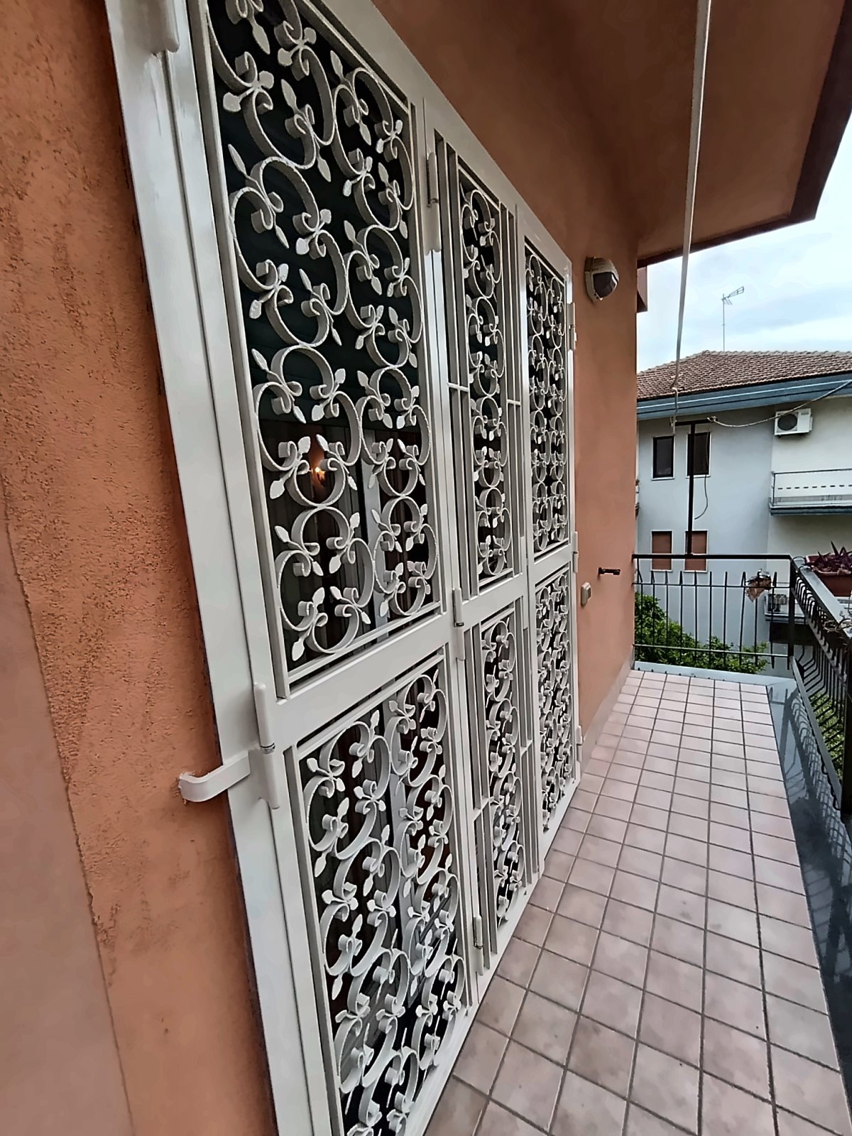 Grata di sicurezza bianca a tre ante per portafinestra, vista laterale